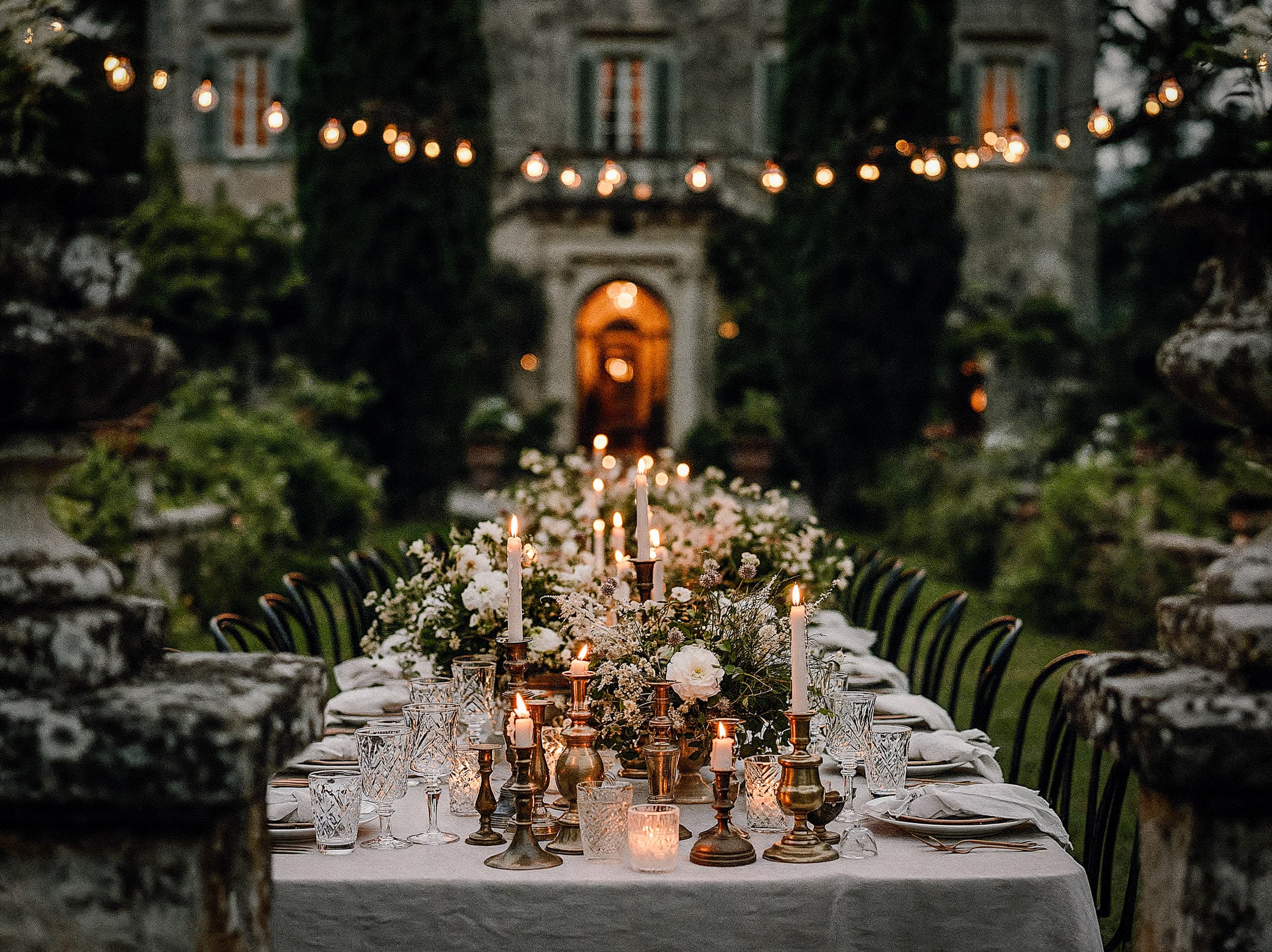 Elegant wedding table design with candles and white florals, luxury Italian ceremony styling