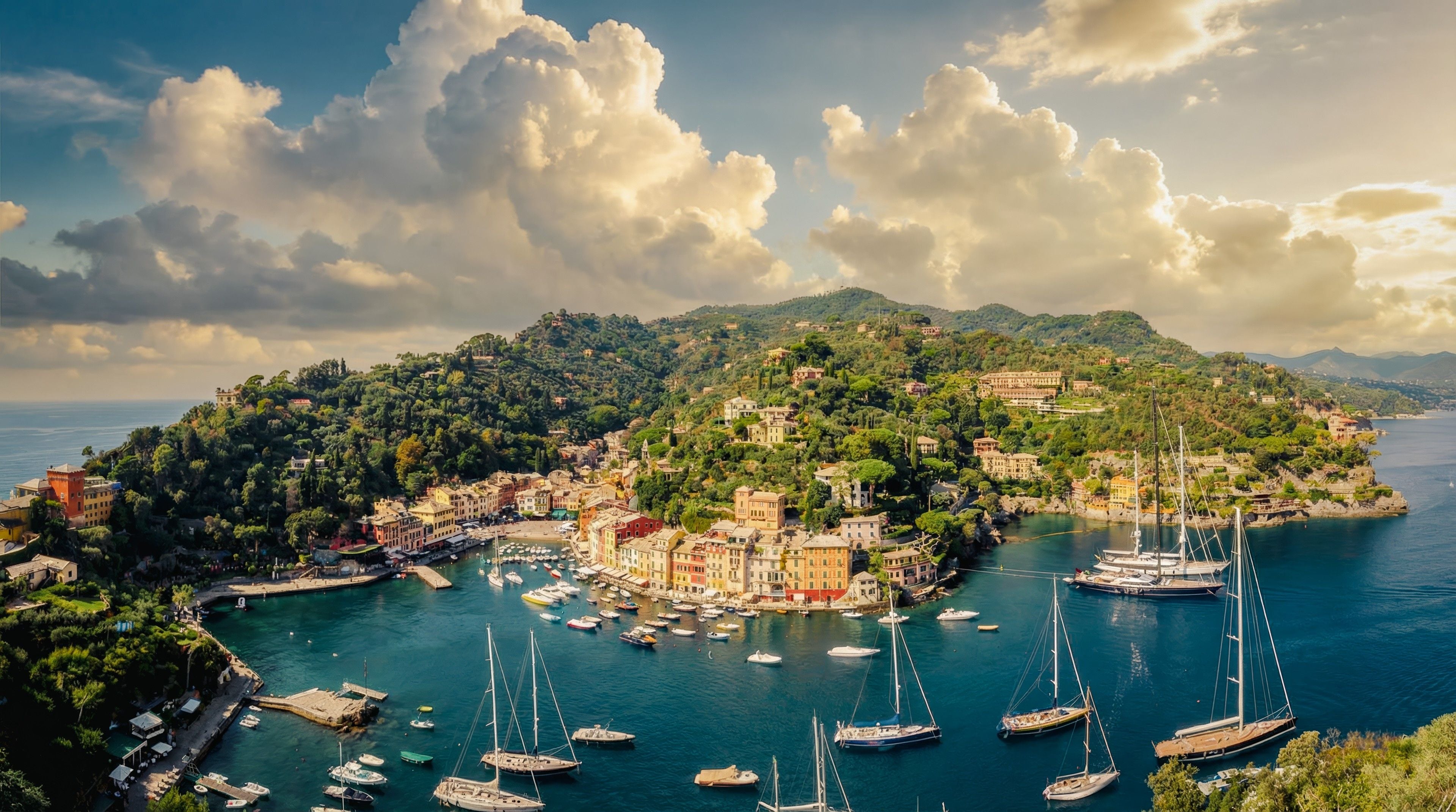Scenic view of Portofino, Italy, showcasing colorful buildings, lush hills, and elegant yachts in a serene harbor.