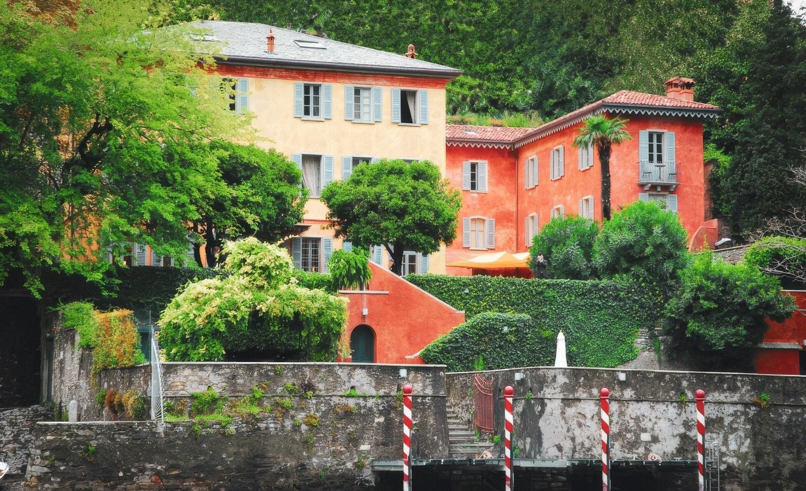 Charming multicolored houses nestled among lush greenery by the waterfront.